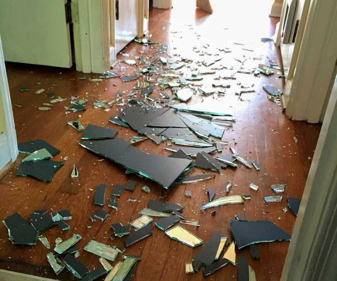 broken mirror shattered in hallway of home