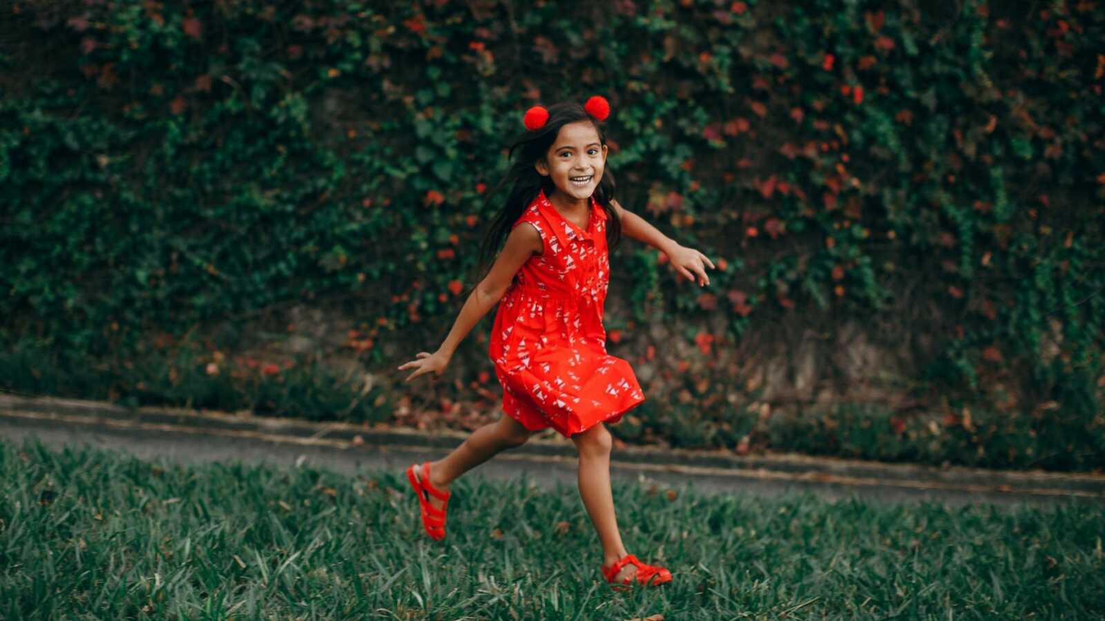 girl walking outside in red dress