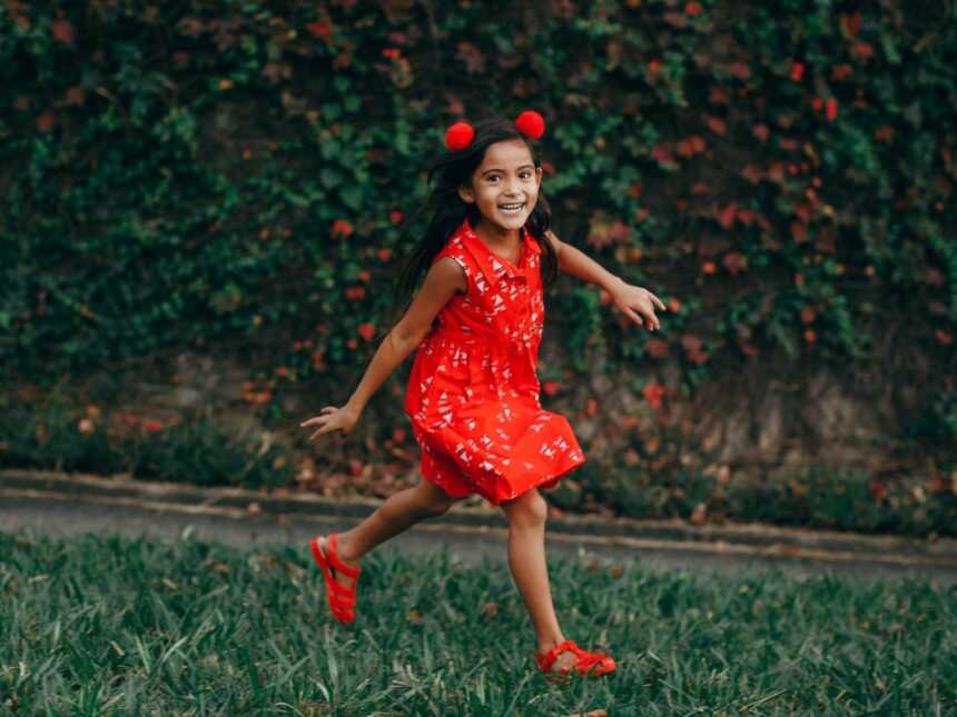 girl walking outside in red dress