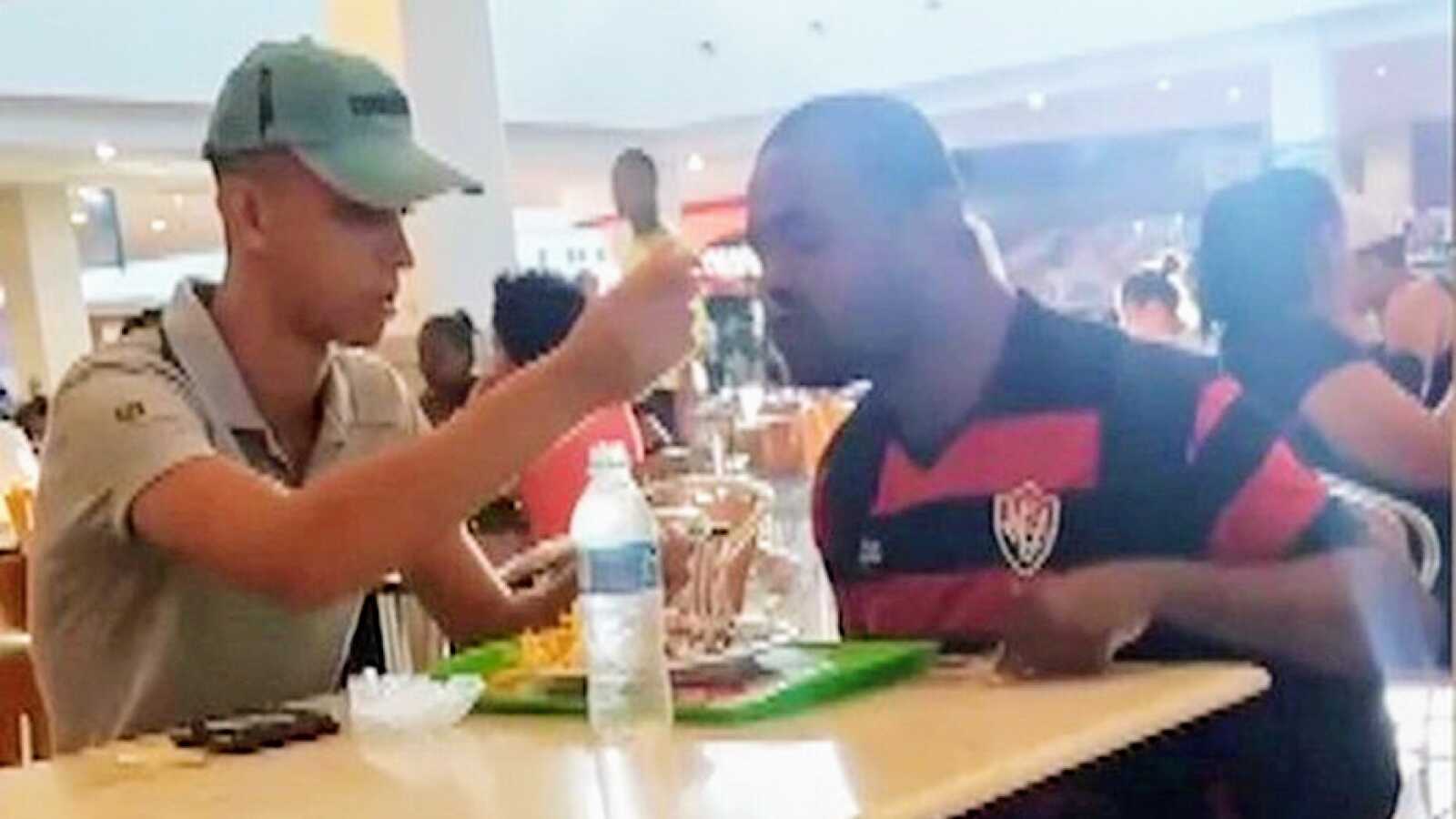 fast food employee feeding disabled customer