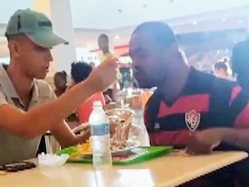 fast food employee feeding disabled customer