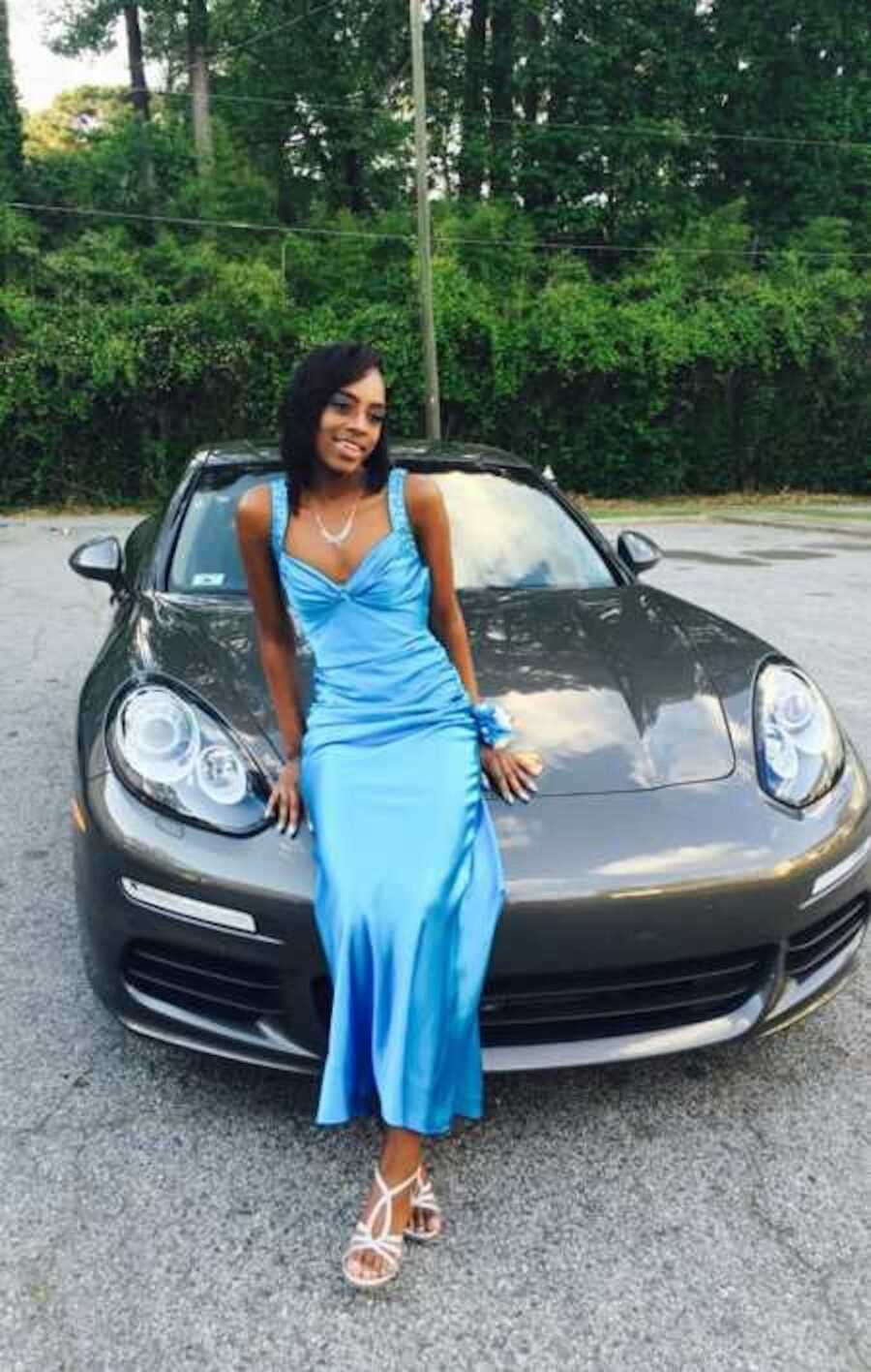 Teen girl wearing blue silk prom dress