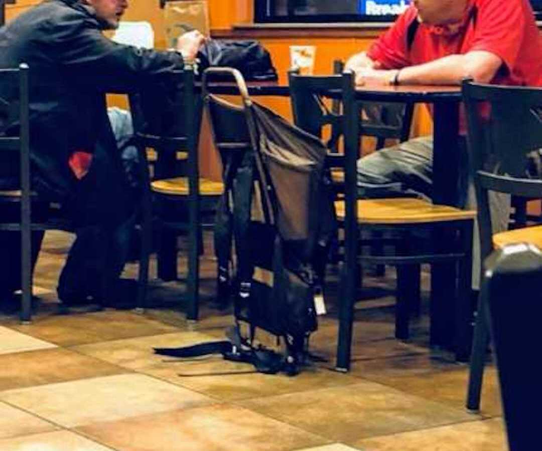two men sitting at table at Taco Bell