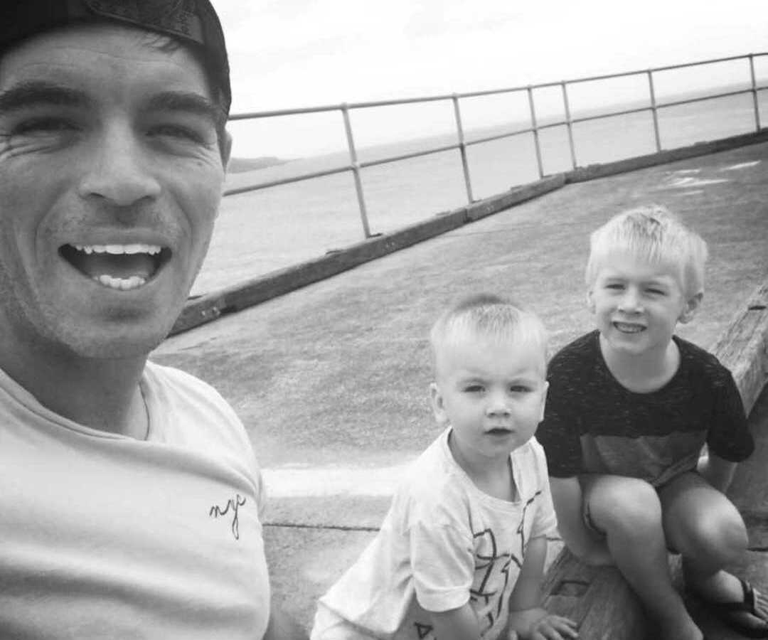 black and white selfie of dad with two young sons