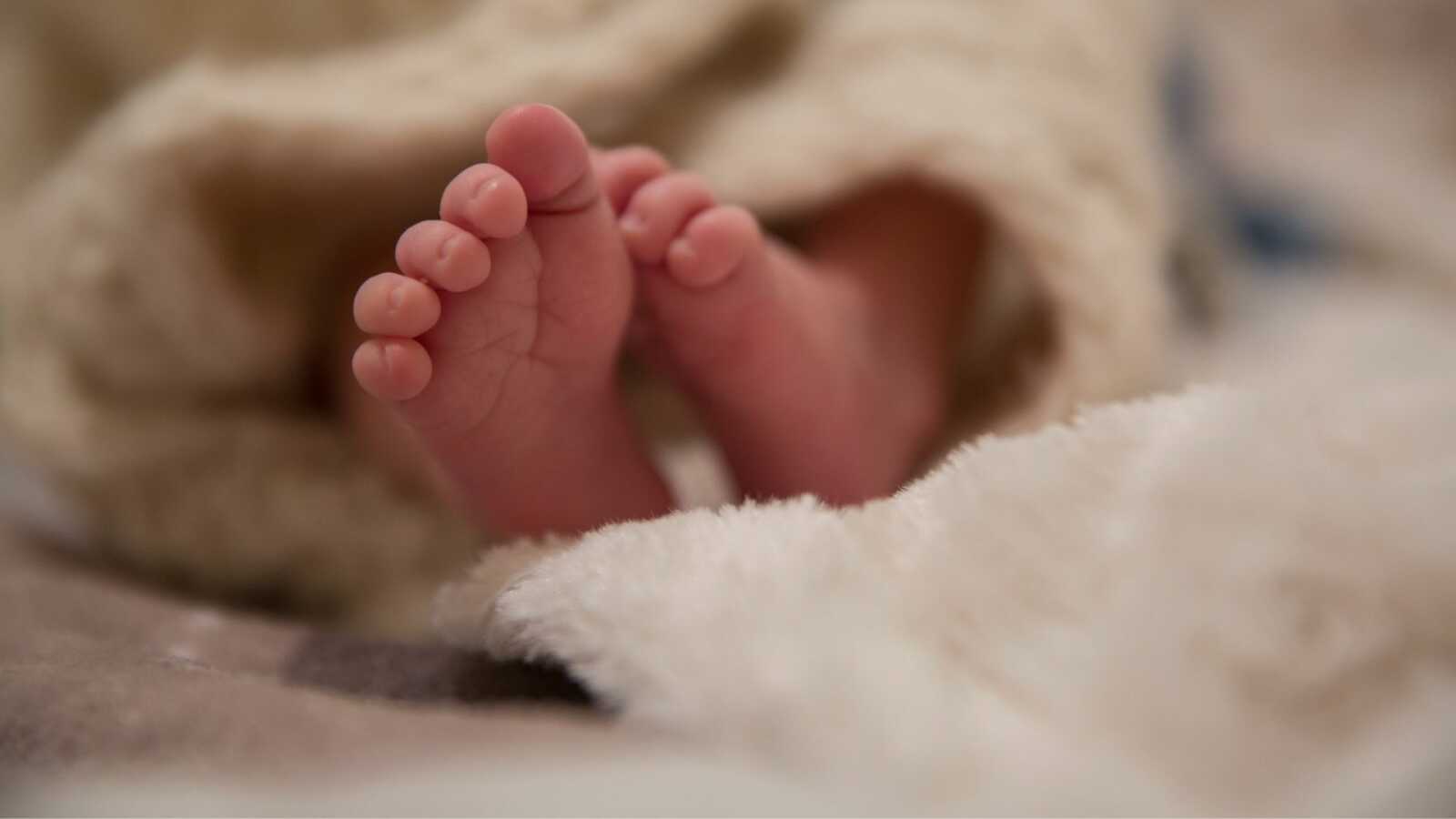 Newborn baby swaddled in blanket