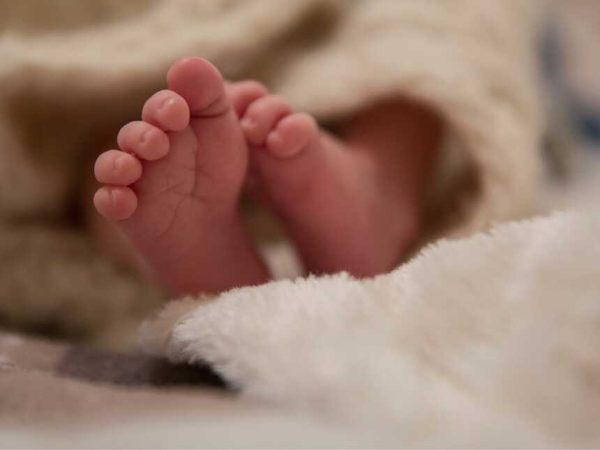 Newborn baby swaddled in blanket