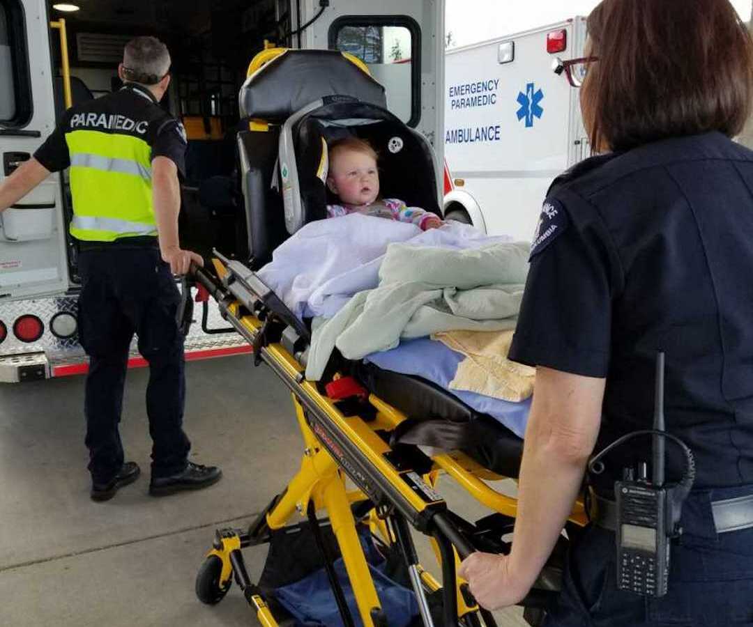 toddler being wheeled into ambulance 