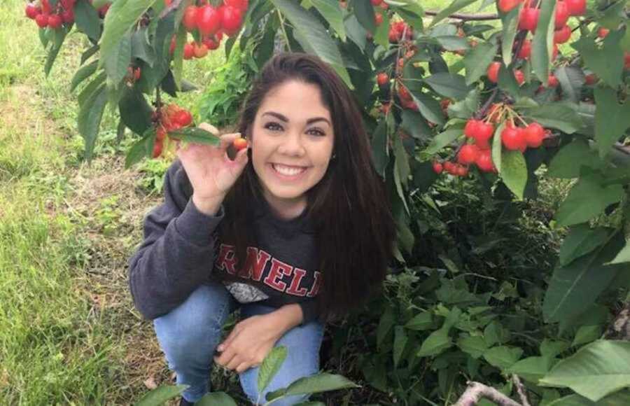 woman holding small fruit