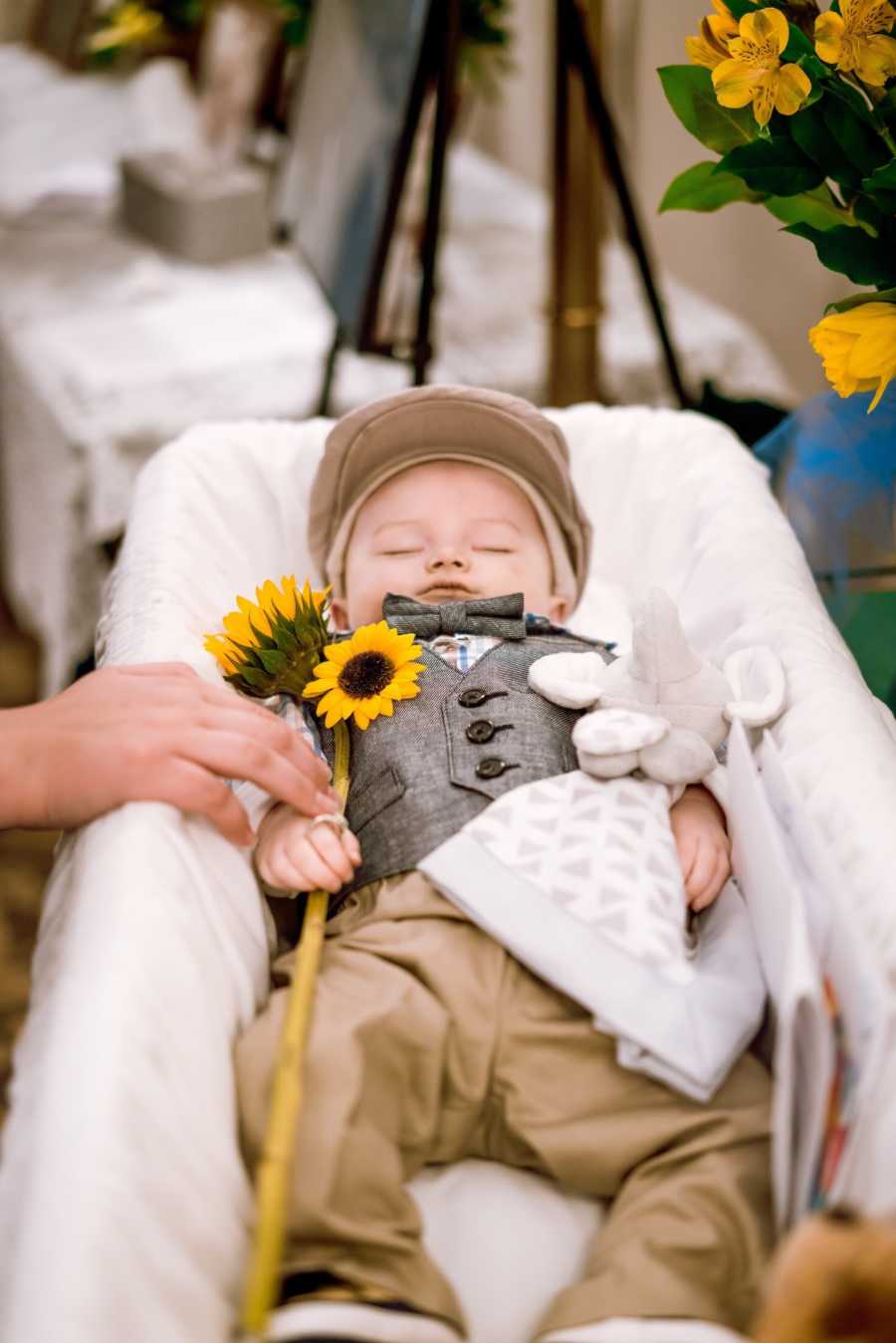 Toddler holding picture frame of her 8 month old brother who passed away