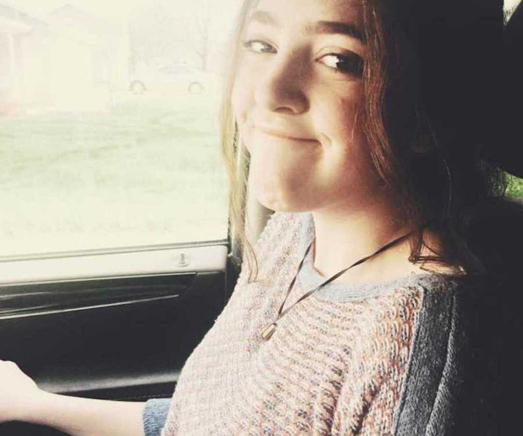 teen girl smiling in passenger seat of car