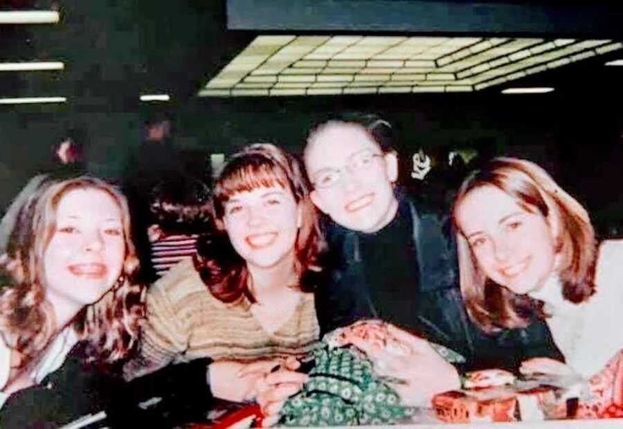 four friends sitting at cafeteria table