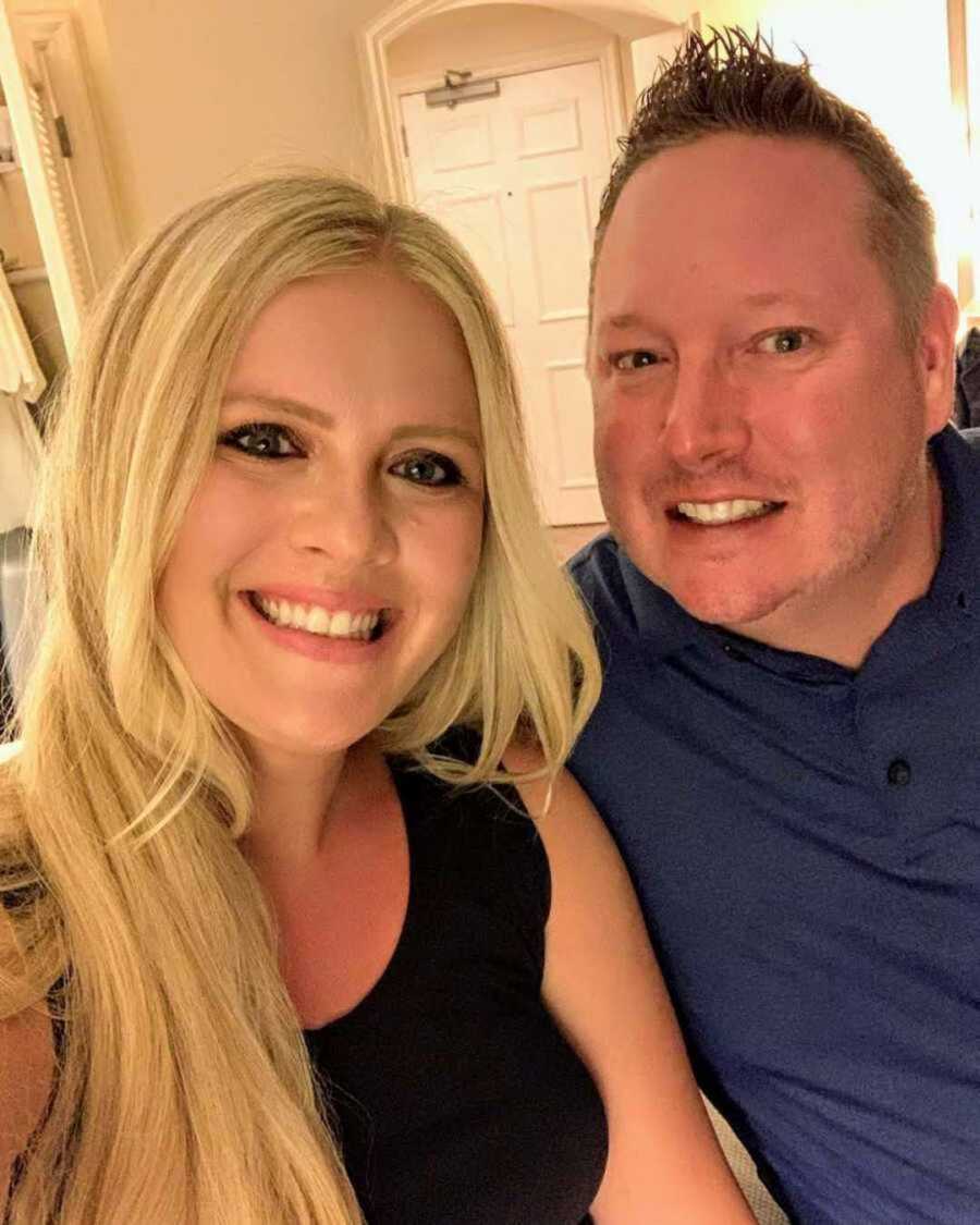 blonde wife smiling next to husband in blue shirt