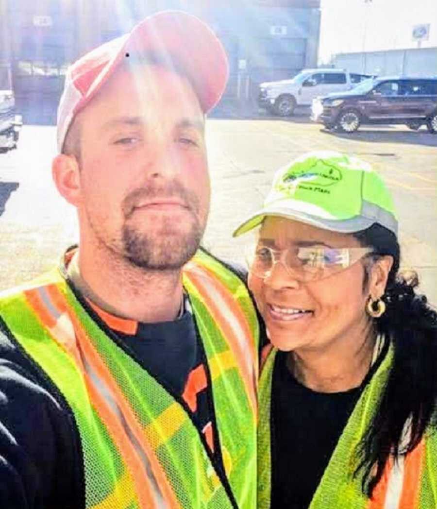 man and woman in construction vests take selfie