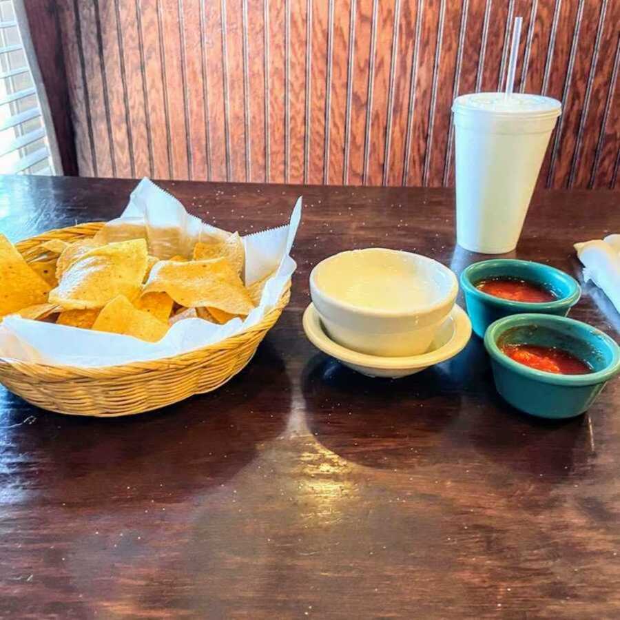 chips, queso, and salsa sitting on a table