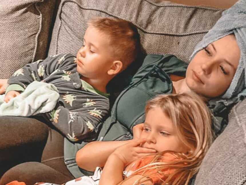 mom laying on couch with 2 kids
