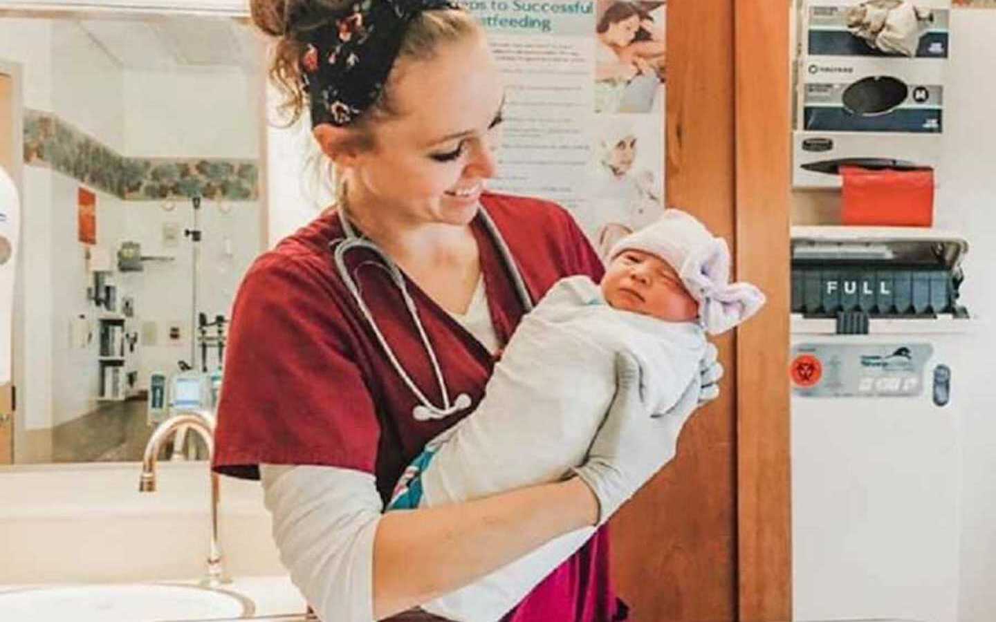 OB nurse holding baby in hospital
