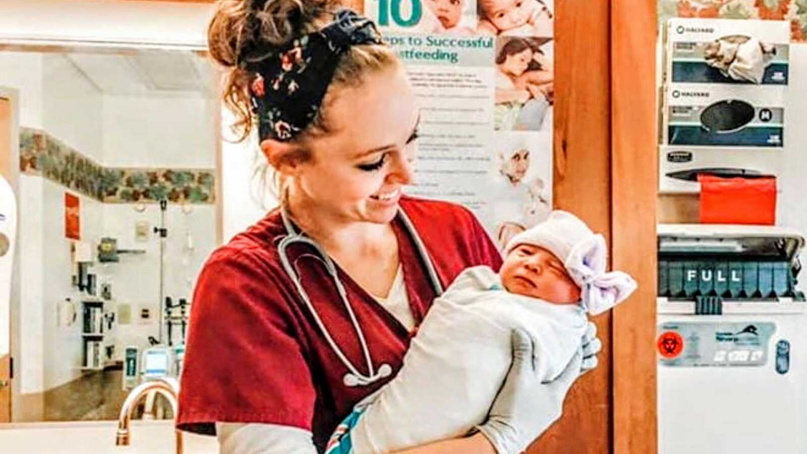 nurse holding baby in hospital
