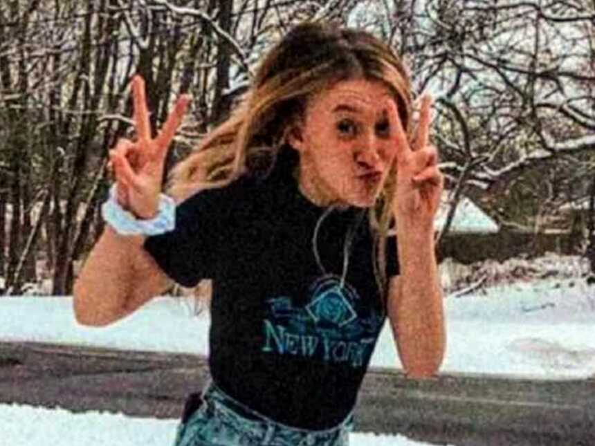 teenage girl jumping outside in snow