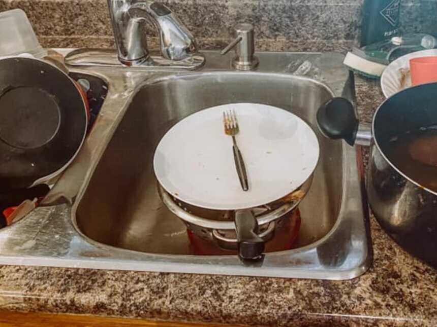 dirty dishes sitting in sink