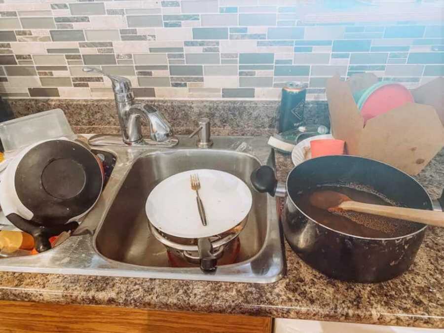 dirty dishes sitting in sink