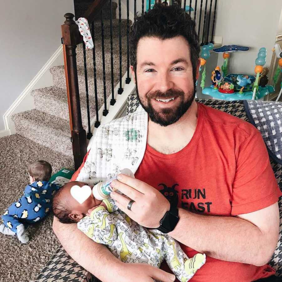 foster dad holding baby in chair