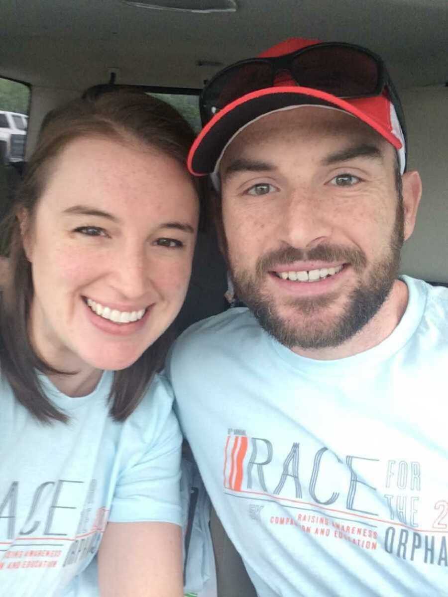 Smiling couple sitting inside car