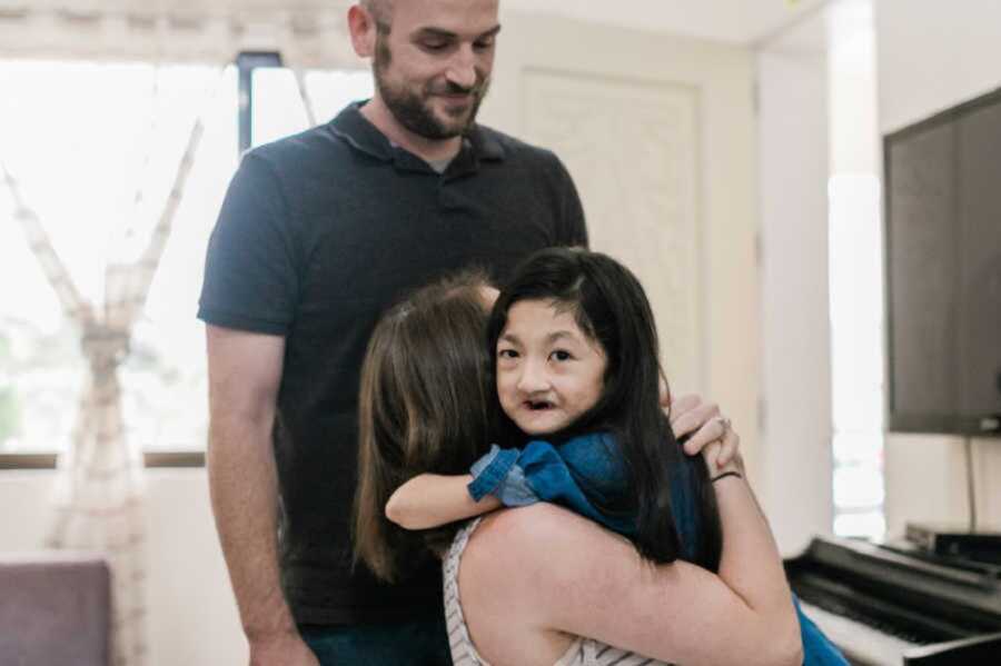 Adoptive mom hugging daughter