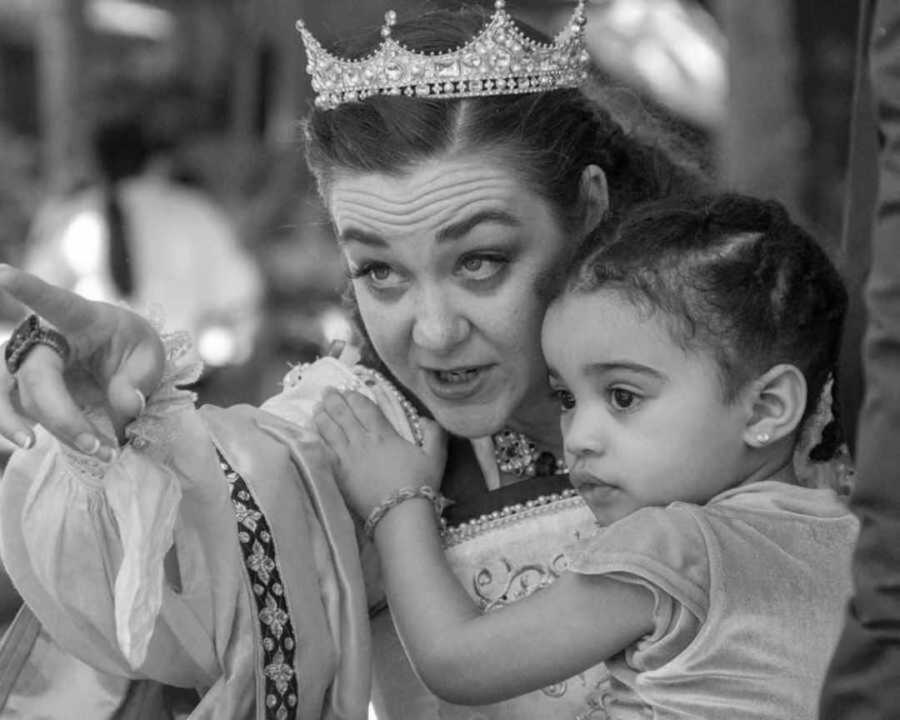 queen holding young girl