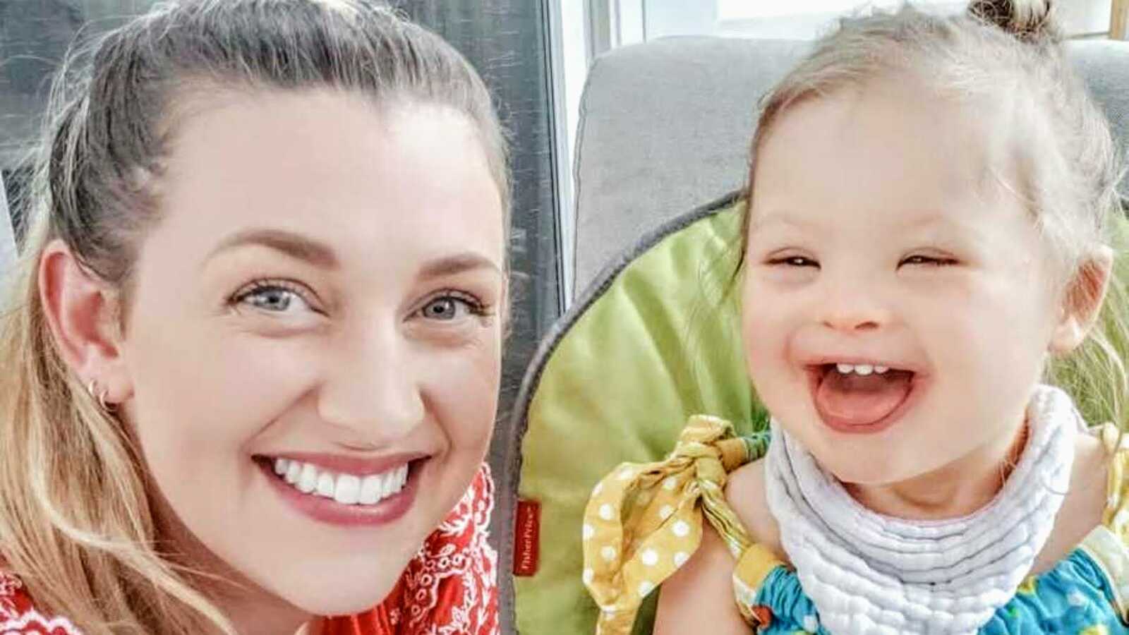 mom smiling with daughter with down syndrome