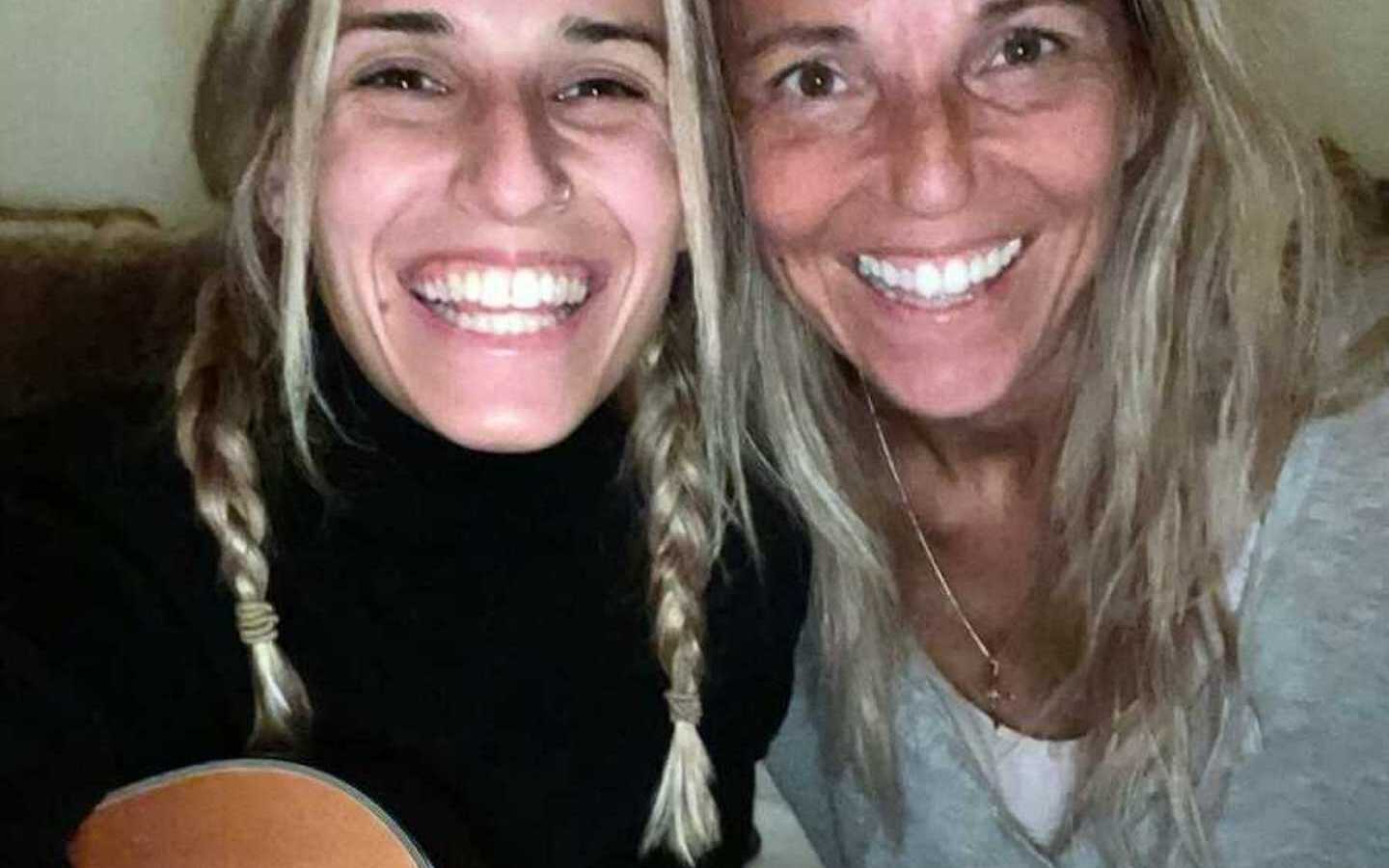 mom and adult daughter smiling in selfie