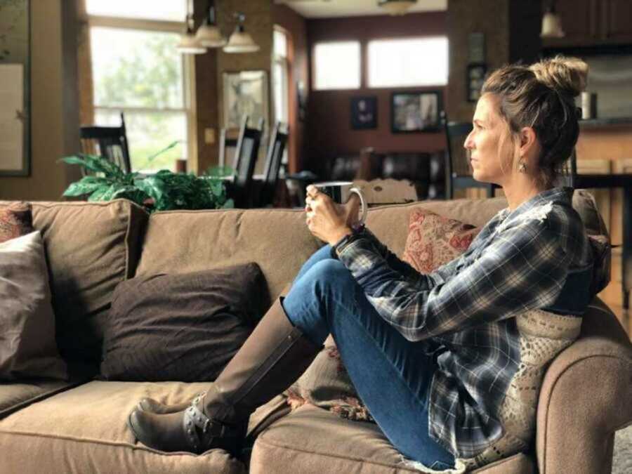 woman on couch with cup of coffee