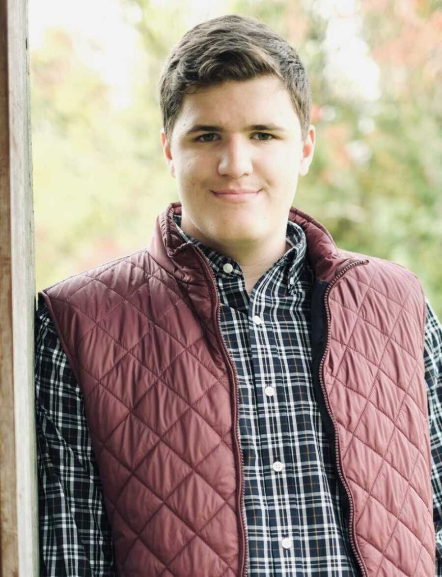 boy with autism smiling outside