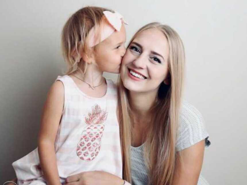 Daughter kissing mom on cheek