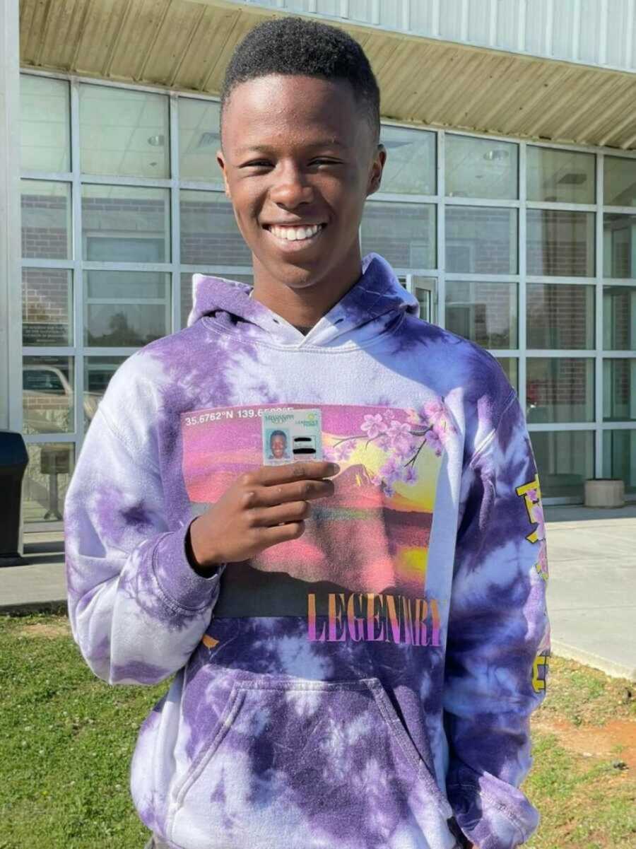 teen boy holding driver's license