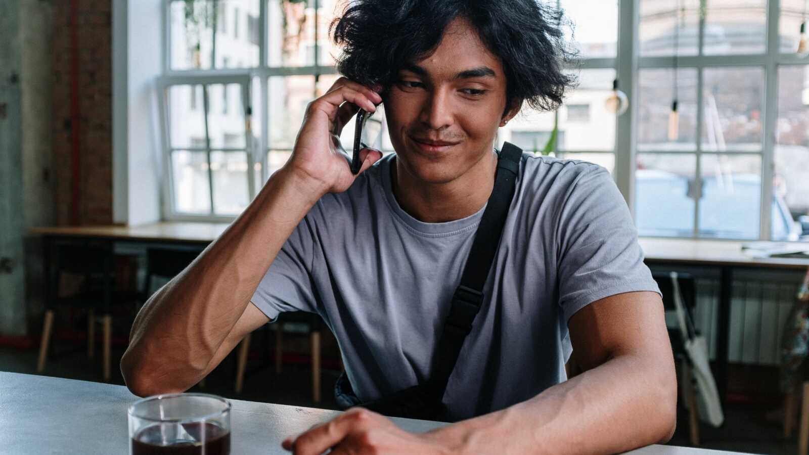 man on phone in coffee ship