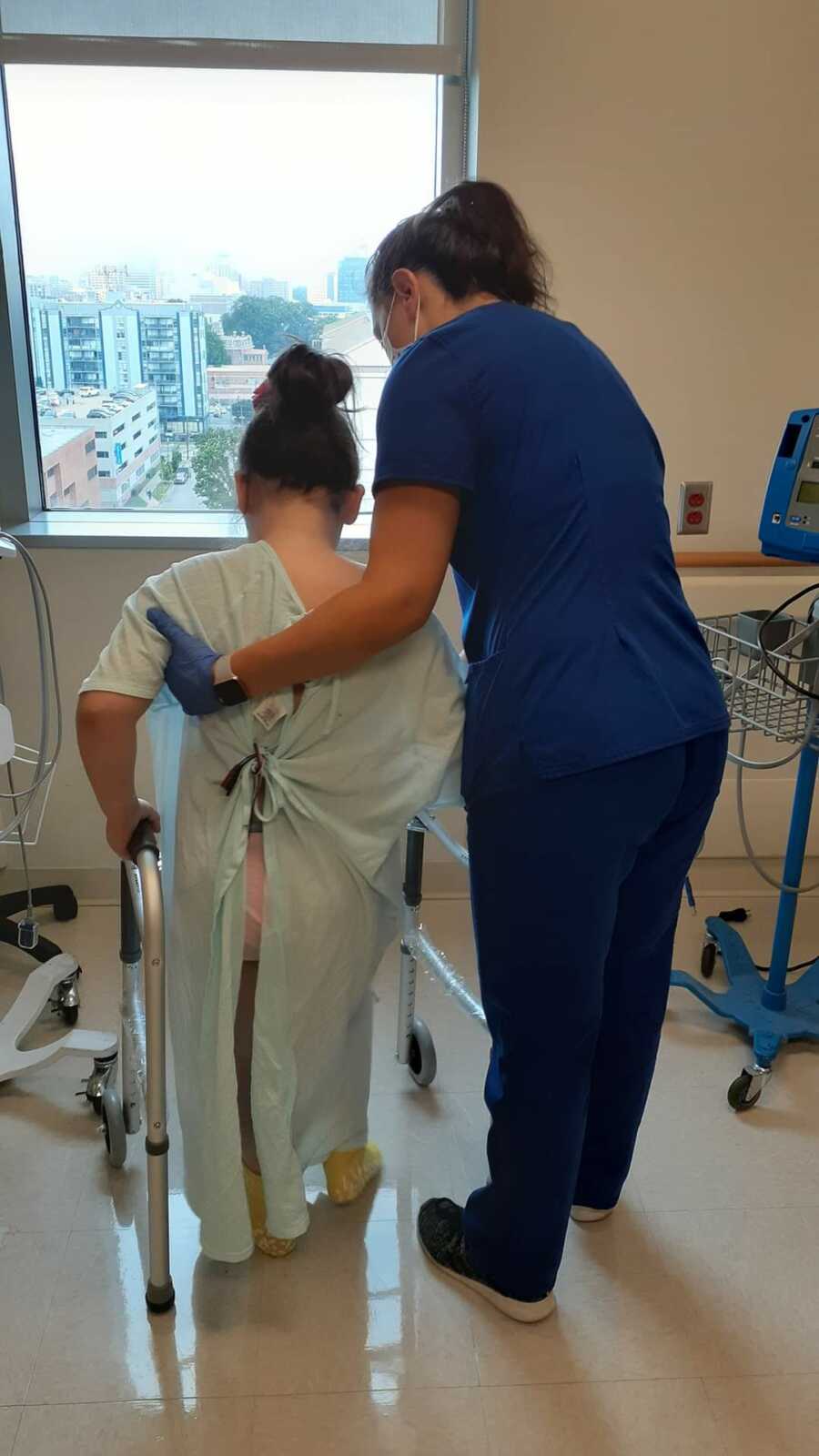 Nurse teaching girl to walk 