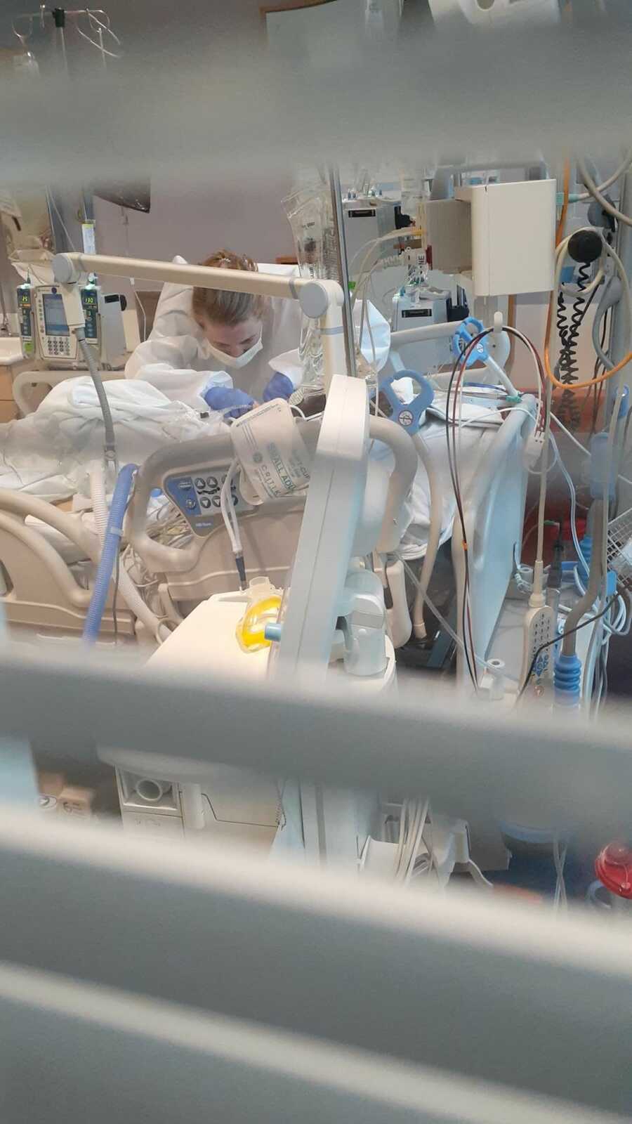 Nurse securing tubes for young female patient