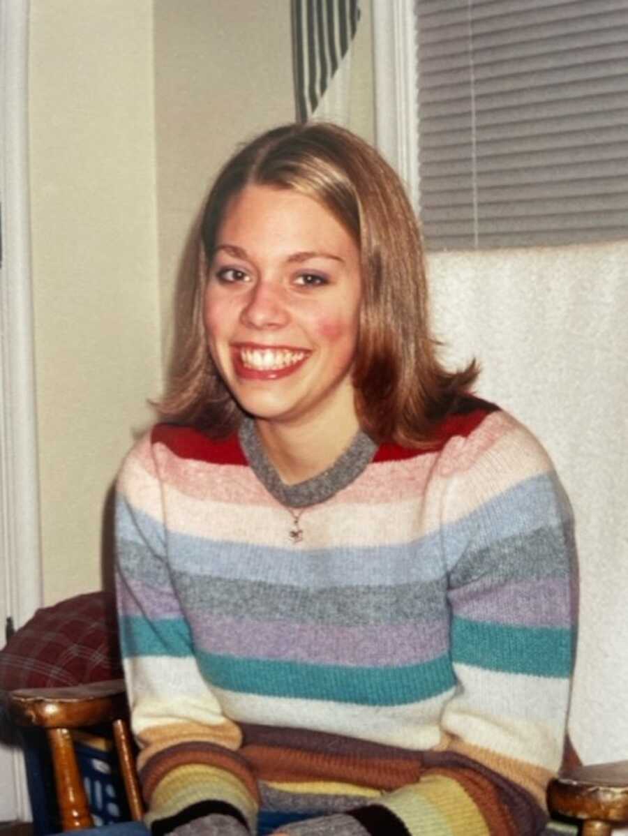 Blonde woman wearing colorful striped sweater
