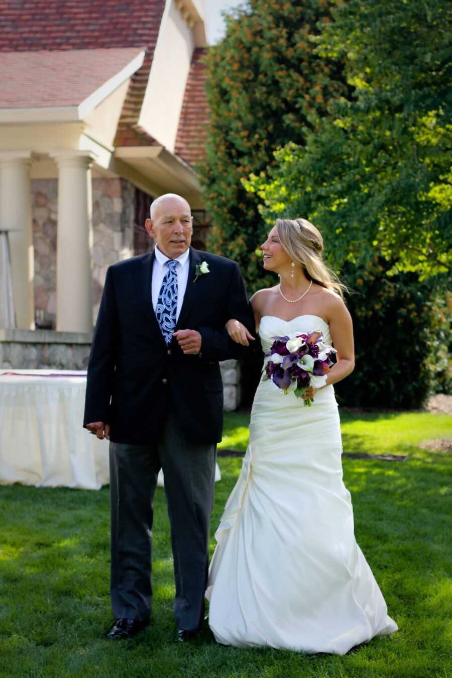 Dad walking daughter down wedding aisle
