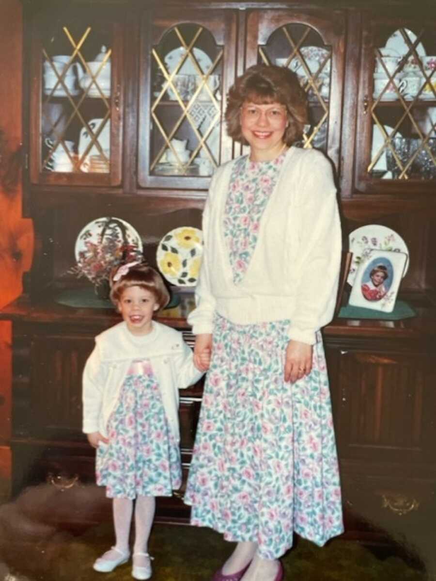 Adoptive mom and daughter wearing matching floral dresses