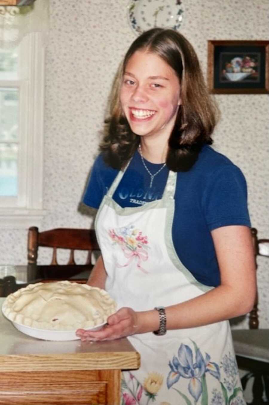 Teen girl baking pie 