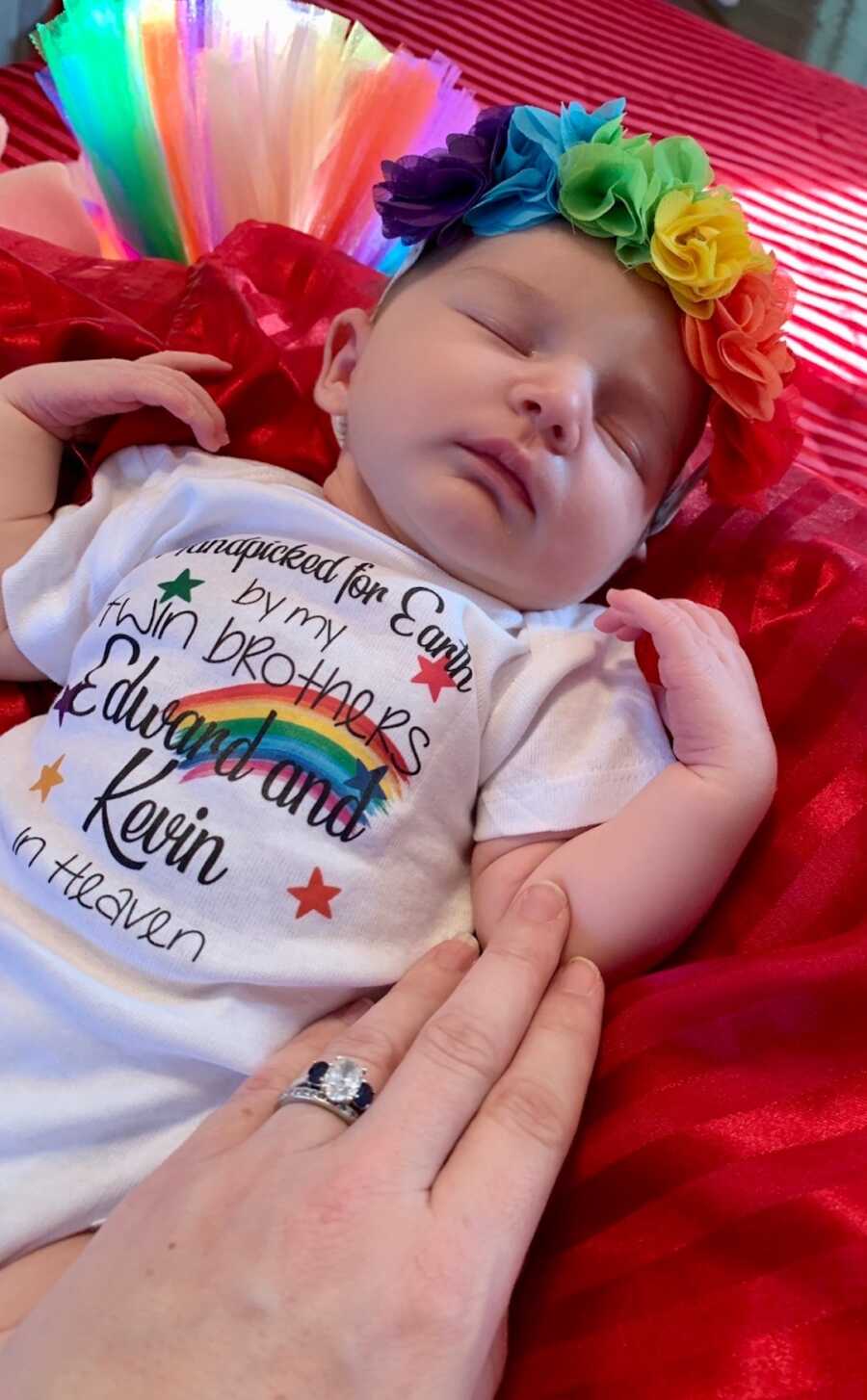 Rainbow newborn baby wearing rainbow flower cron