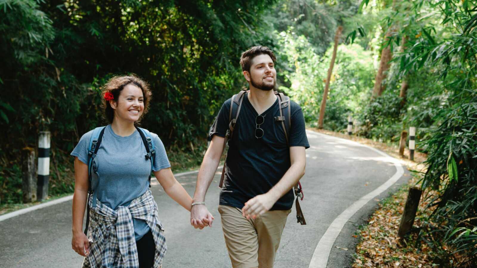 couple holding hands on a hike