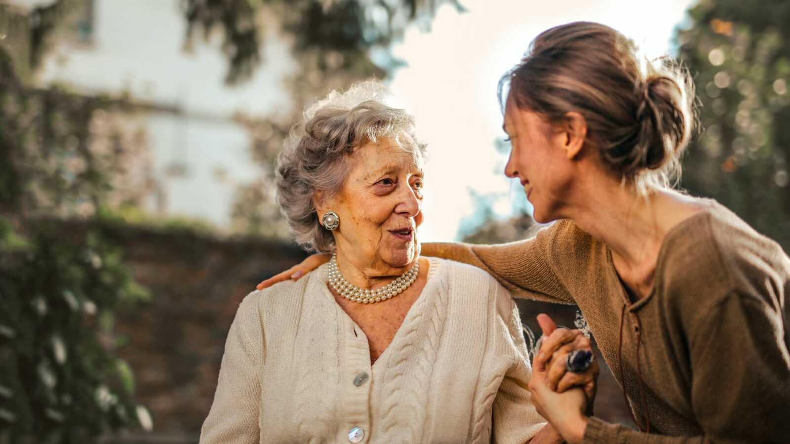 older woman speaking with young woman