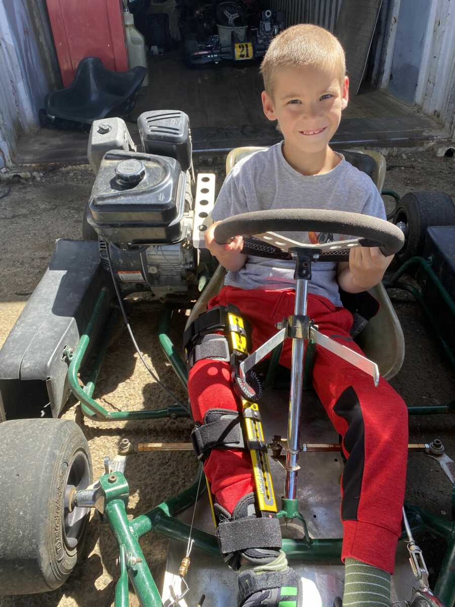 Boy smiling while sitting in go-kart