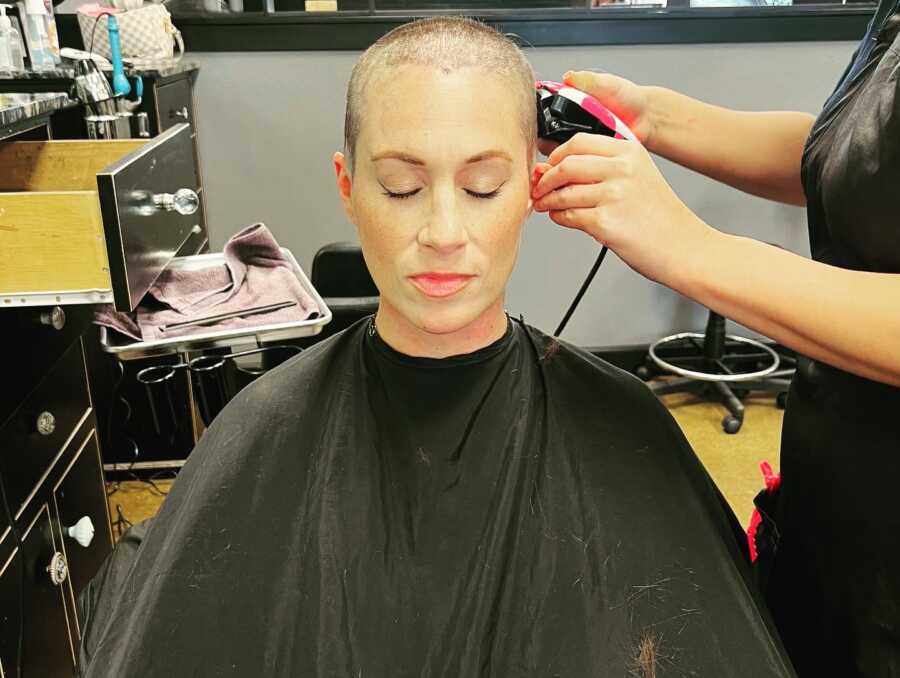 Cancer patient getting head shaved in salon