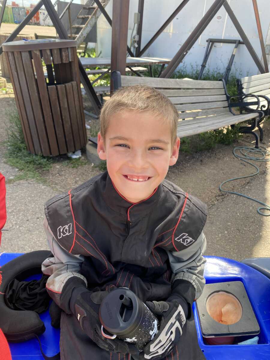 Smiling boy in racing attire