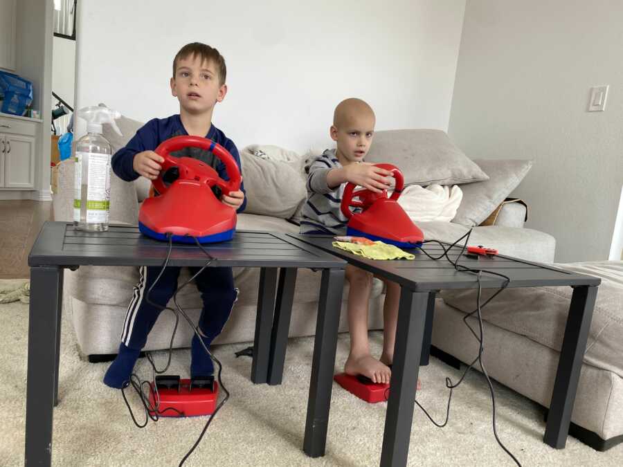 Two boys playing racing video game