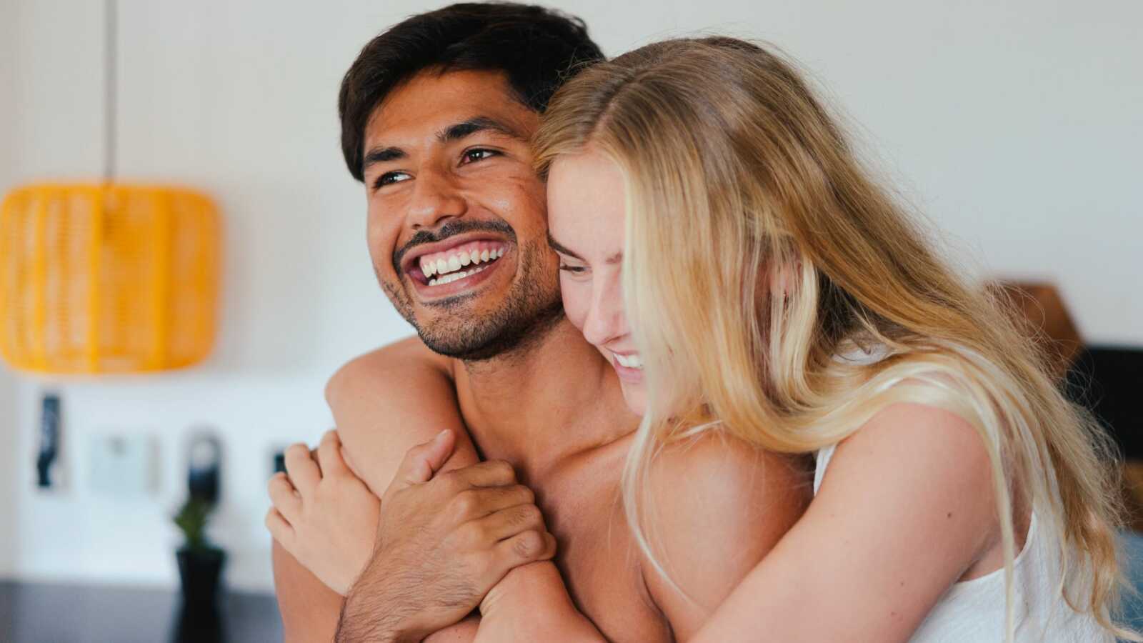 a woman hugging a man from behind