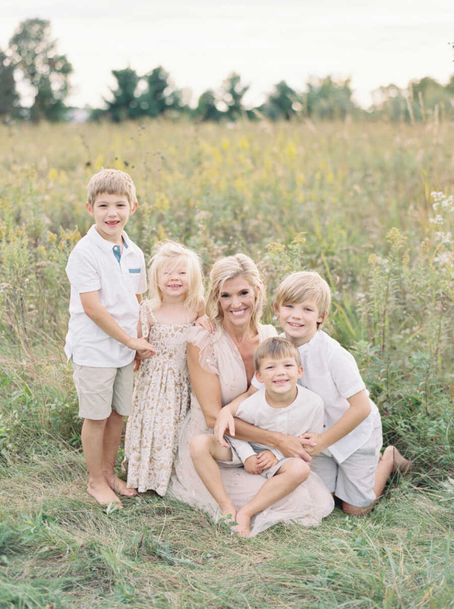 Woman and four children outside in a field